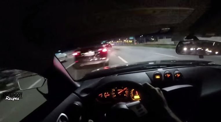 Nissan 350Z knalt tussen het verkeer door op snelweg
